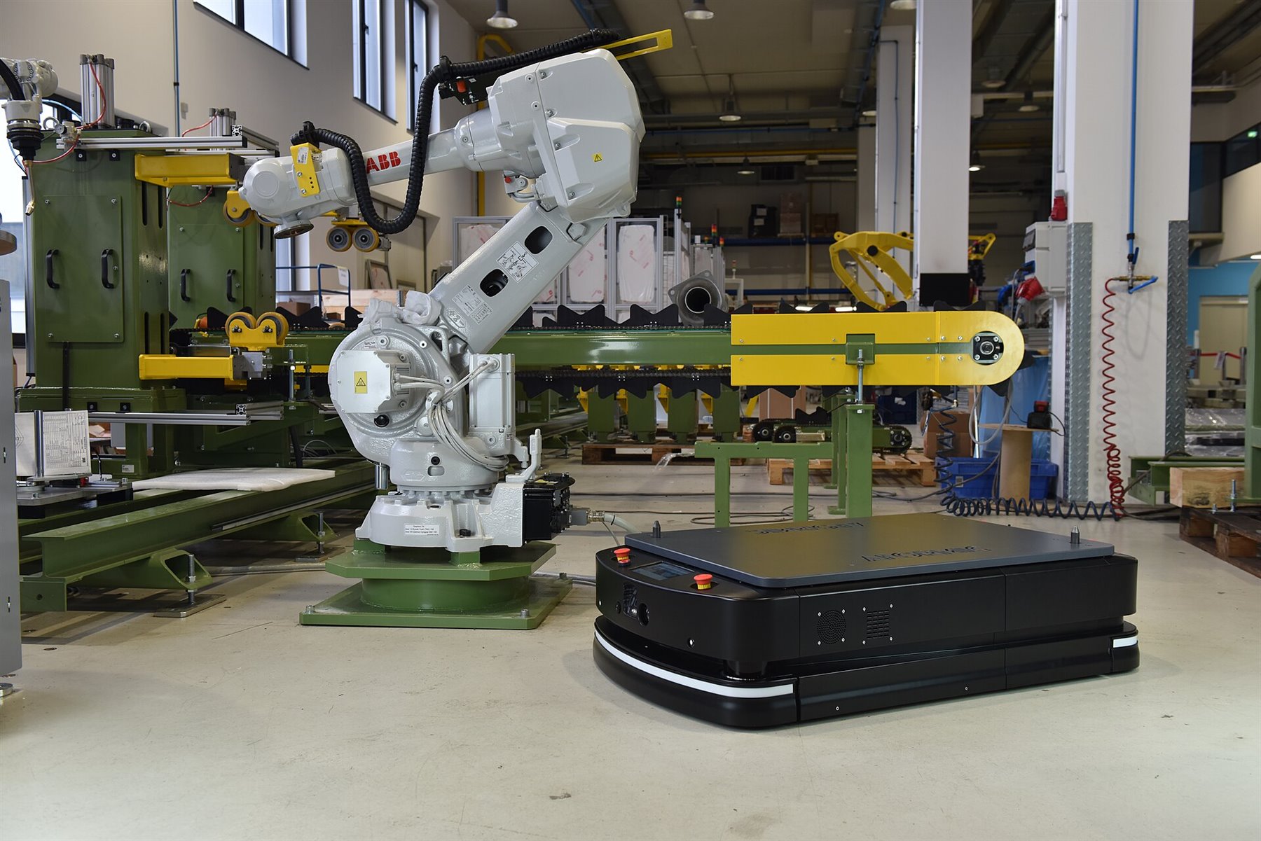 Automated guided vehicle in an industrial setting representing B2B distribution, logistics and AI-native marketplace operations.