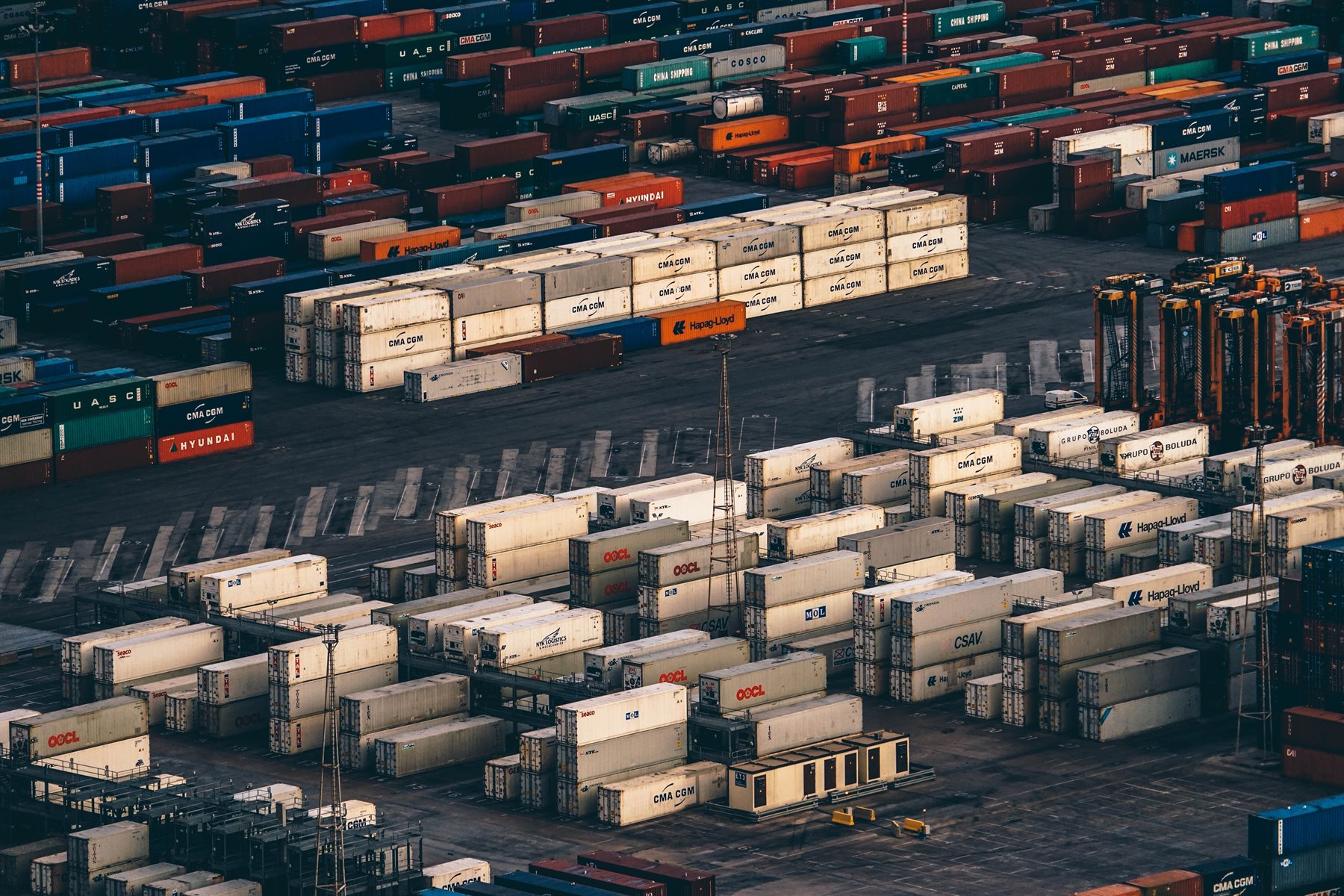 Shipping containers stacked at a major port, representing global expansion and cross-border market infrastructure.